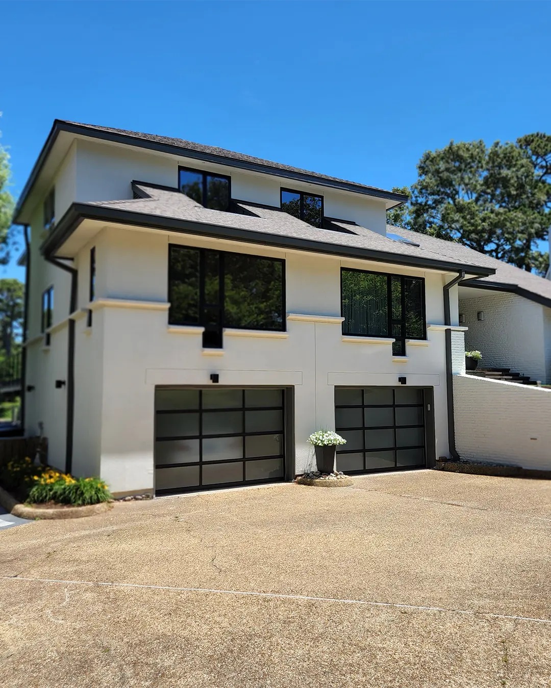 Modern white stucco home exterior painted by Top Coat Custom Paint